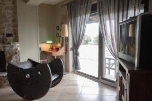 - un salon avec un canapé et une porte coulissante en verre dans l'établissement Leveniotis Villa, à Angelochórion