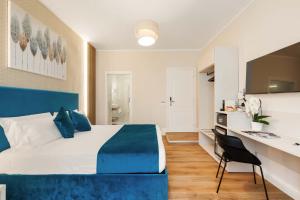 a hotel room with a large bed and a desk at AlbaDea Deluxe in Rome