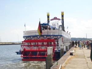 a large boat is docked at a dock at Maisionette Wohnung im Hafenmeisterhaus Lauterbach in Lauterbach