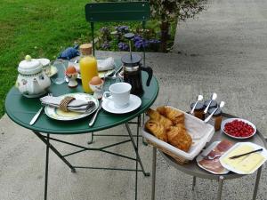 a green table with breakfast food on it at Manoir Saint Martin in Percy
