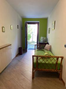 a room with a bed and a hallway with a door at CA' DEI PAOLI in Pieve Vergonte