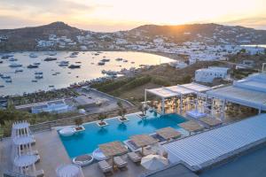 an aerial view of a resort with a harbor at Once in Mykonos - Designed for Adults in Ornos