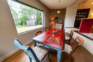 a dining room with a table and chairs and a window at Railway Cottage in Killin +16 photos
