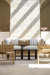 a living room with a couch and two chairs at Le Couvent des Minimes Hôtel & Spa L'Occitane in Mane