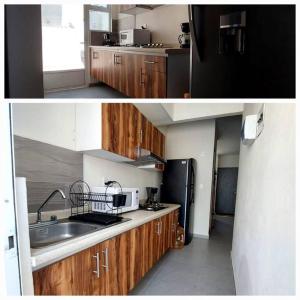 uma cozinha com um lavatório e um frigorífico preto em Casa Paraíso - Brandeburgo em Veracruz