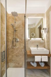 a bathroom with a sink and a shower at AlbaDea Deluxe in Rome