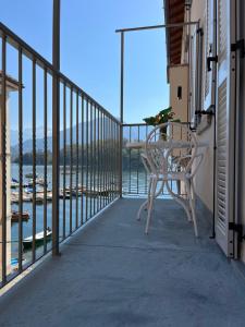 a patio with a table and a chair on a balcony at Casa Castellana Apt 1 e Casa Castellana Apt 2 in Sala Comacina