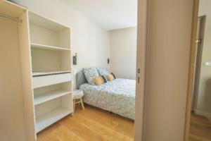 a small bedroom with a bed and a closet at Le Palm Appartement élégant & Design En Bord Rivière in Collobrières