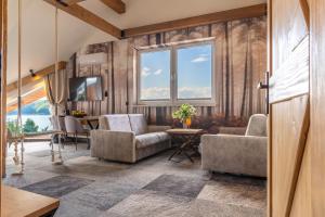 a living room with a couch and chairs and a table at Sztygarka Hetmańska Resort Solina in Solina