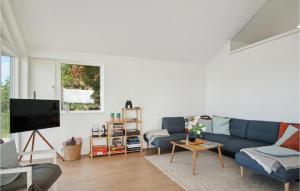 a living room with a blue couch and a tv at Beautiful Home In Slagelse With Wifi in Slagelse