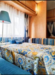 a bedroom with a bed with a blue and white comforter at Love in the Camper in Florence
