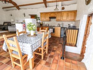 a kitchen with a table and chairs in a room at Y Bwthyn in Betws-y-coed +10 photos