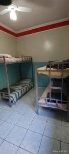 a room with two bunk beds and a table at Rex Hotel in Marília