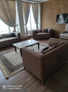 a living room with couches and a coffee table at Himalaya Villas in Murree