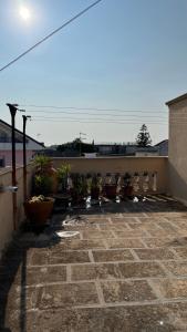 a patio with potted plants on the side of a building at Casa Giusy in San Marzano di San Giuseppe +43 photos