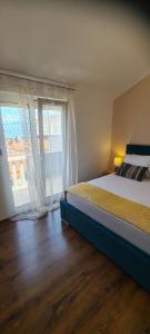 a bedroom with a bed and a large window at Apartments Mery in Supetar