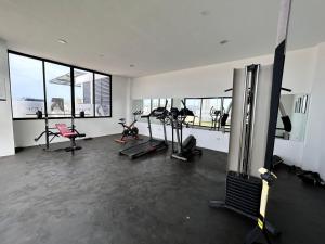 a gym with treadmills and exercise equipment in a building at condesa 12 sublime depa a 100 pasos de la playa in Mazatlán