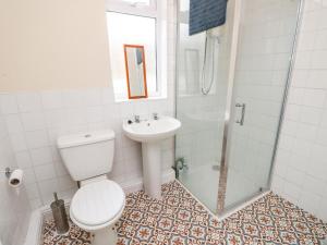 a bathroom with a toilet and a sink and a shower at Station Avenue in Sandown +24 photos