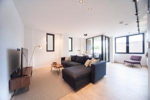 a living room with a couch and a tv at Charming 1Bed Apt with Balcony - Steps from Tube in London