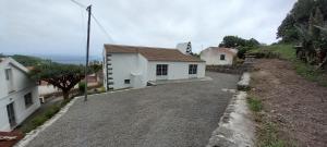 a house on the side of a dirt road at Fazenda Apartments - Apartment 3 in Lajes das Flores