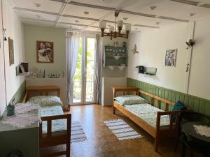 a room with two beds and a table at Ubytování u babičky in Peruc