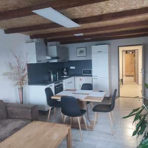 a kitchen and dining room with a table and chairs at Ubytování U nás na Moravě in Moravská Nová Ves