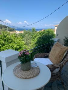 a white table and chairs on a balcony at Harry's Studios in Gaios