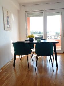 a dining room with a table and two chairs at City Apartment Dora in Makarska +12 photos