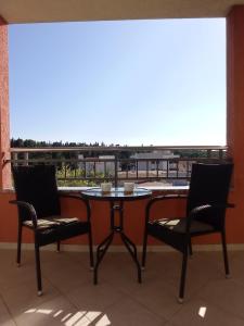 a table and chairs with a view of a balcony at City Apartment Dora in Makarska
