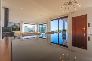 a large room with a view of the water at Livingtarifa - Casa Los Helechos in El Bujeo