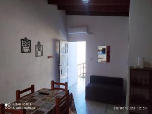 a living room with a table and a blue couch at Departamento Rosales Nro 2 in Valeria del Mar +15 photos