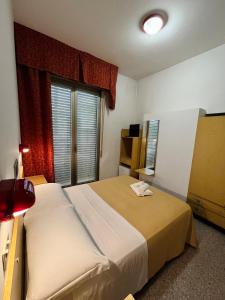 Postel nebo postele na pokoji v ubytování Hotel Columbia Frontemare