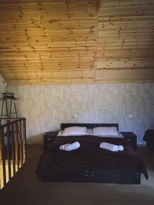 a bedroom with a bed with two pillows on it at Cottage Shina in Kazbegi