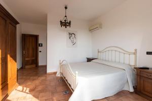 a bedroom with a white bed in a room at Villa Il Torchio in Messina