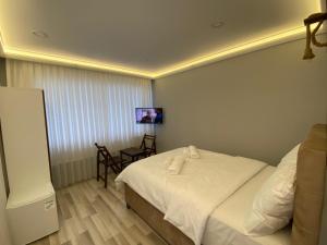 Postel nebo postele na pokoji v ubytování Yamaç Çam Hotel