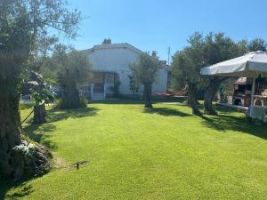 un patio con árboles y una casa blanca en TERRY'S VILLA en Mákri