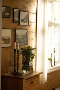 a room with a table with two candles and a window at Hotel Aak in Åndalsnes