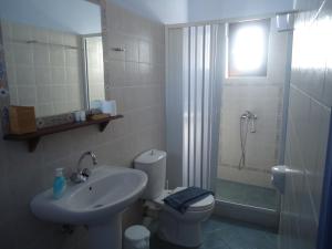 a bathroom with a sink and a toilet and a shower at Kois Studios in Azolimnos