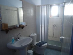 a bathroom with a sink and a toilet and a shower at Kois Studios in Azolimnos Syros