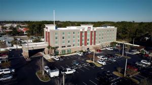 an aerial view of a large building with a parking lot at Hampton Inn & Suites Jacksonville Beach Boulevard/Mayo Clinic in Jacksonville