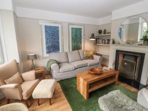 a living room with a couch and a fireplace at Beech Croft in Keswick