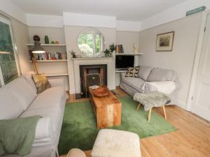 a living room with a couch and a table at Beech Croft in Keswick