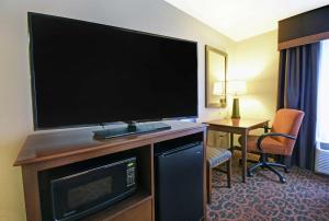 a large flat screen tv in a hotel room at Hampton Inn Beloit in Beloit