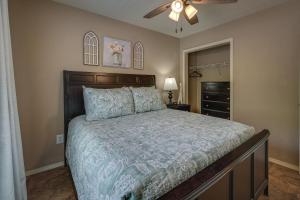 a bedroom with a bed and a ceiling fan at Centrally Located Branson Condo Step-Free Access in Branson