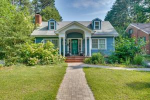 a blue house with a green door and a brick driveway at 2 Mi to Duke University Durham Tiny Home! in Durham