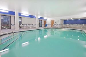 a large swimming pool with blue water in a building at Hampton Inn Jackson in Jackson