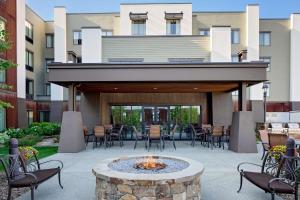 une terrasse avec un foyer extérieur en face d'un bâtiment dans l'établissement Homewood Suites by Hilton Kalispell, à Kalispell