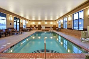 a pool in a hotel with tables and chairs at Homewood Suites by Hilton Kalispell in Kalispell