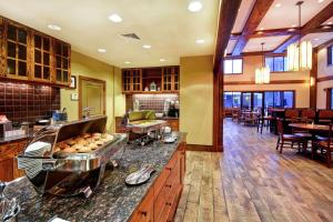 a restaurant with a counter with some food at Homewood Suites by Hilton Kalispell in Kalispell