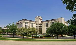 a large white building with a tower on top of it at Hampton Inn Overland Park in Overland Park